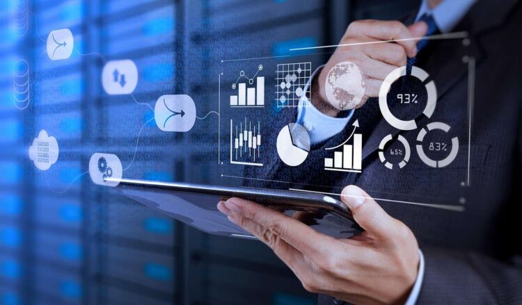 Digital Performance & Observability Analytics Business professional using a tablet with digital analytics and performance dashboards representing system metrics and observability insights.<br />
Used in CTA to training catalogue, workshops and contact.