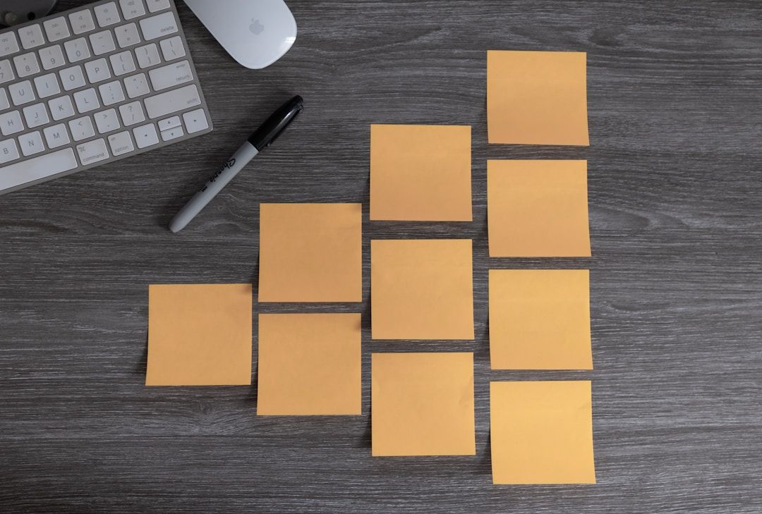 Sticky notes arranged on a desk next to a keyboard and marker, representing task breakdown and planning used in performance engineering and observability training.