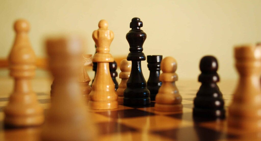 Observability excellence chess A black and white photo of chess pieces symbolizing strategy, used here as a metaphor for observability and strategic decision‑making in complex systems.