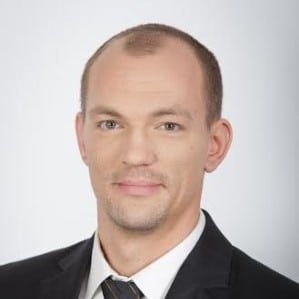Portrait of Ádám Trenyik, Test Automation Instructor, in a professional setting.